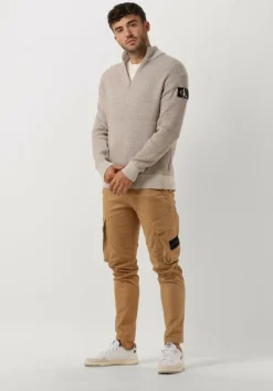 beige calvin klein trui badge plated half zip sweater
