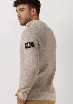 beige calvin klein trui badge plated half zip sweater