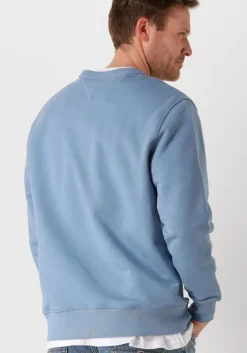 blauwe tommy jeans sweater tjm reg badge crew ext